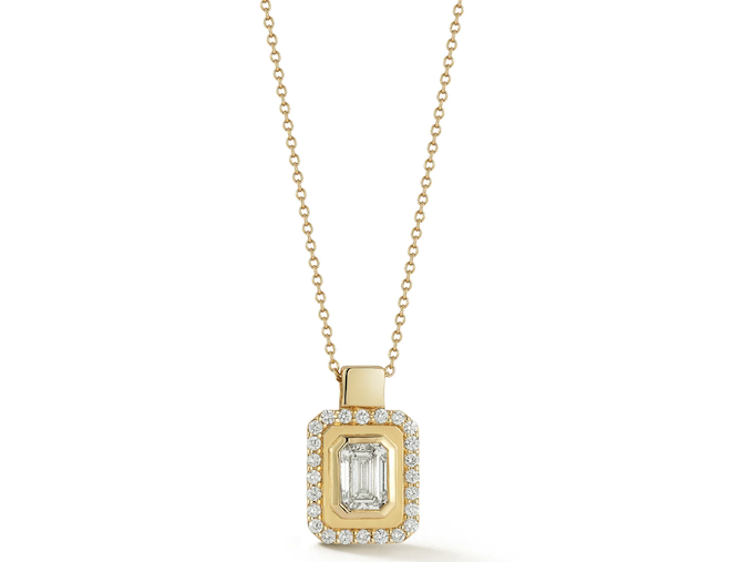 Gold necklace with emerald cut diamond center. 